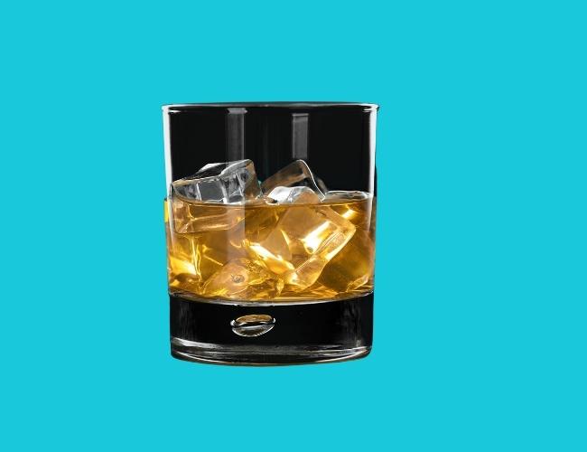 Wine in a glass with ice cube. Don't feed this to your pet dog