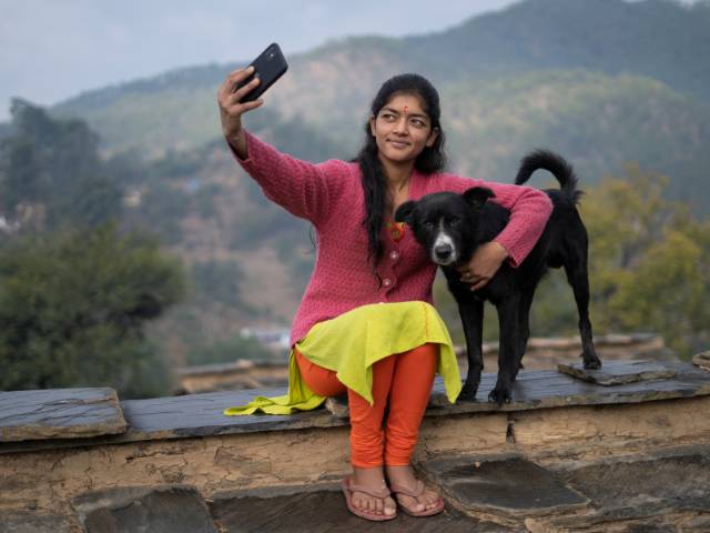 indian female owner taking selfie with indian desi dog